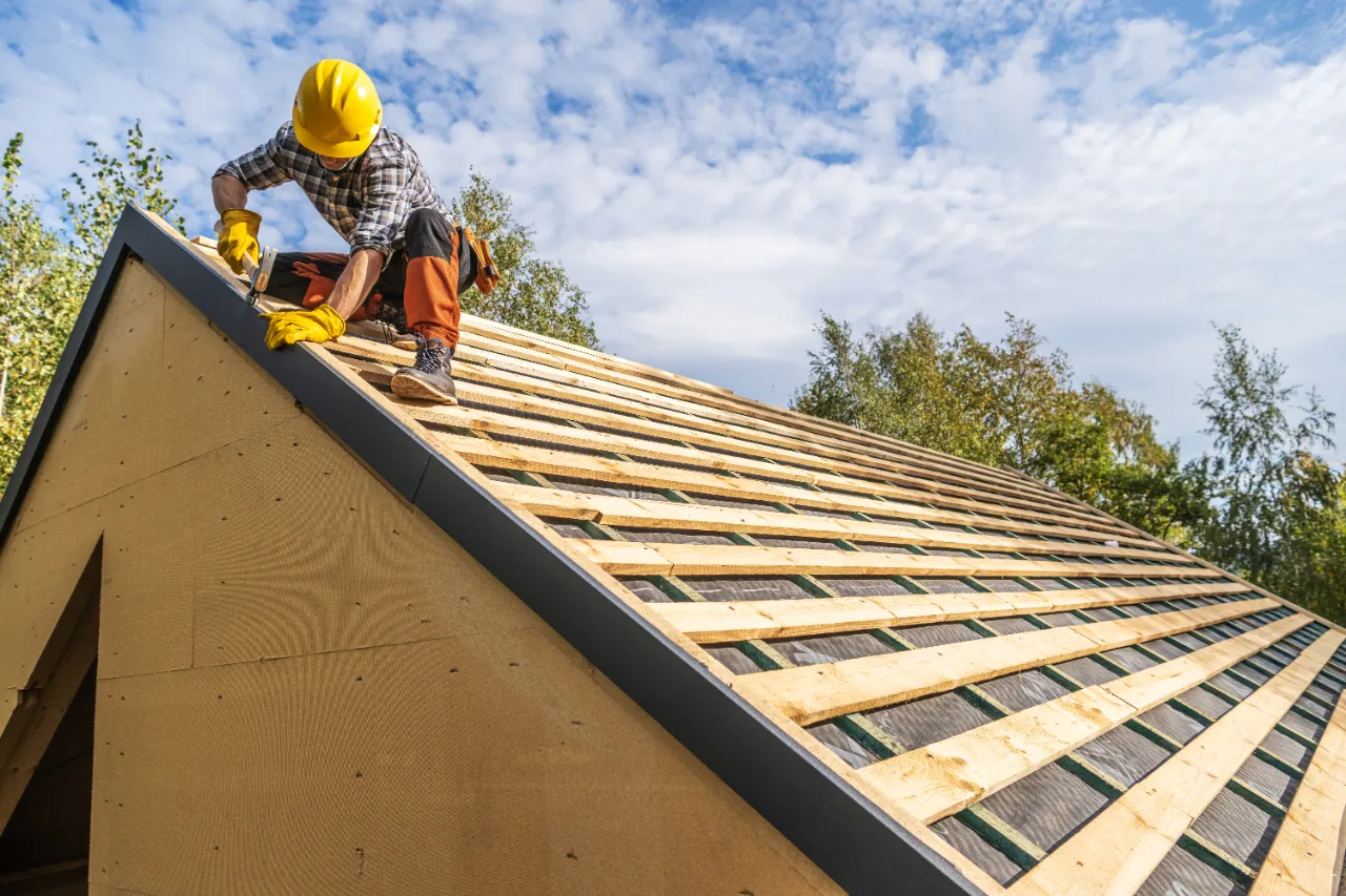 Roofer inspecting Connecticut roof